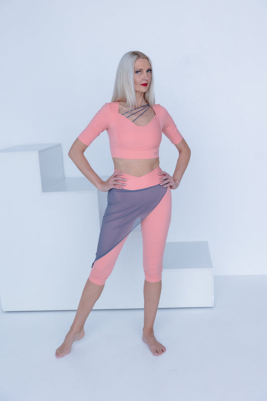 Woman wearing a pink and gray outfit on a white background