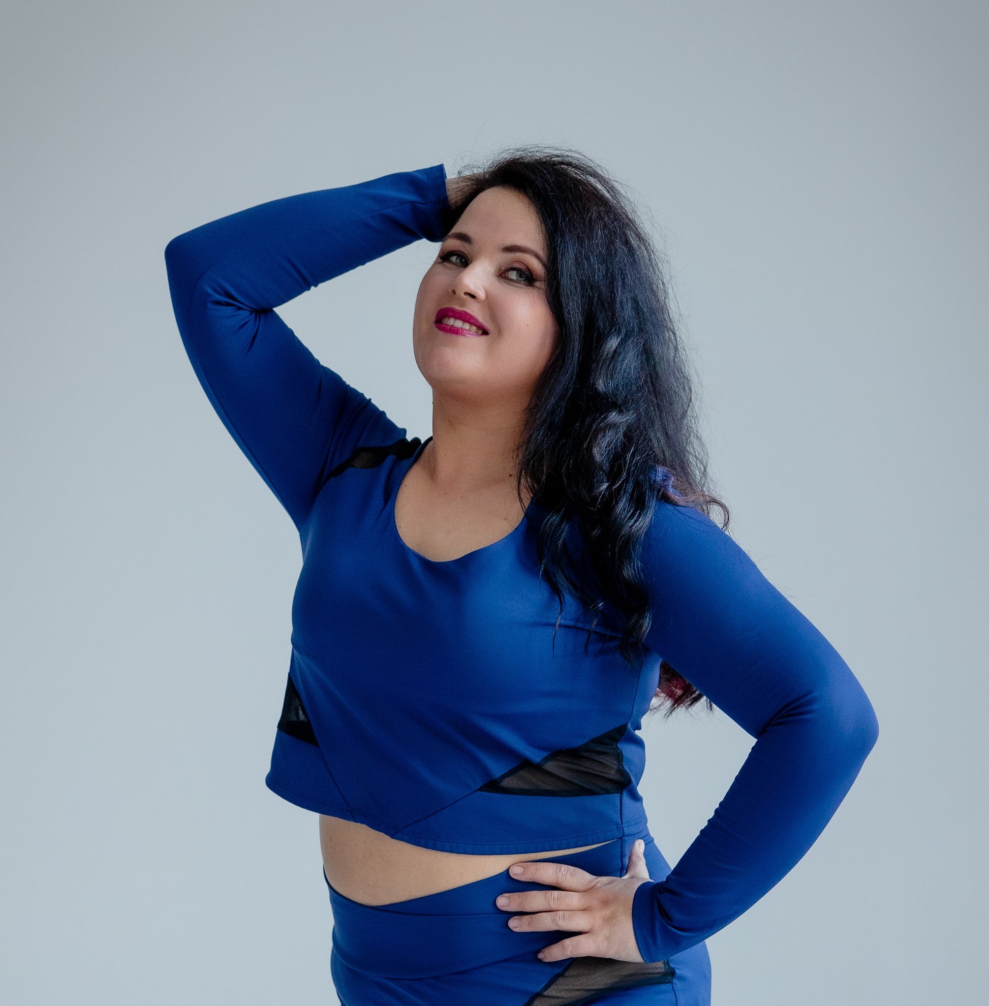 Woman wearing a blue outfit against a plain background